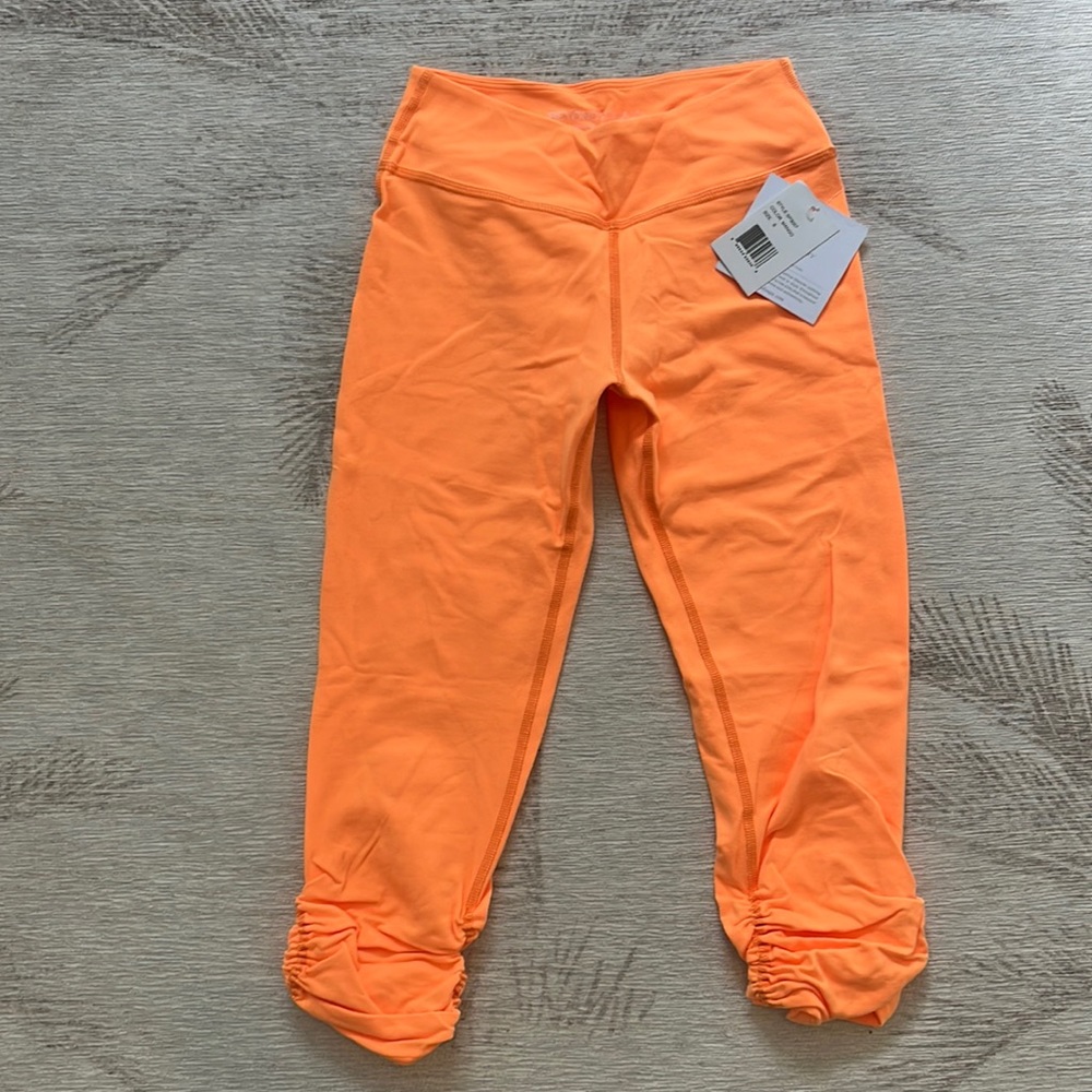 NWT Beyond Yoga ruched capri leggings in mango orange. Size S.